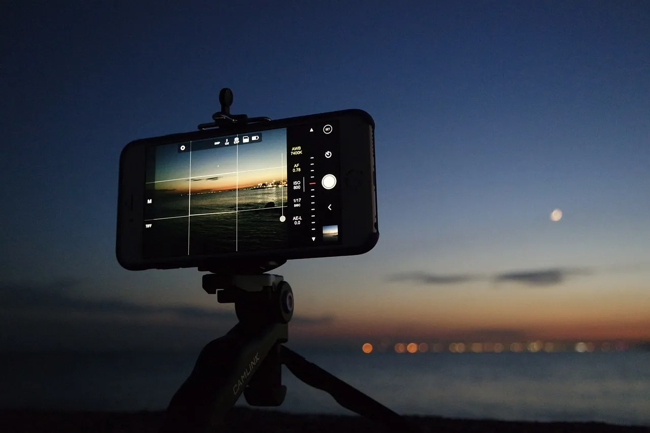 A phone on a tripod facing an evening sky