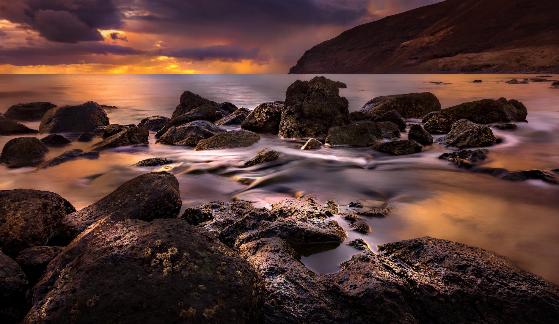 boulders of rocks on the sea shore