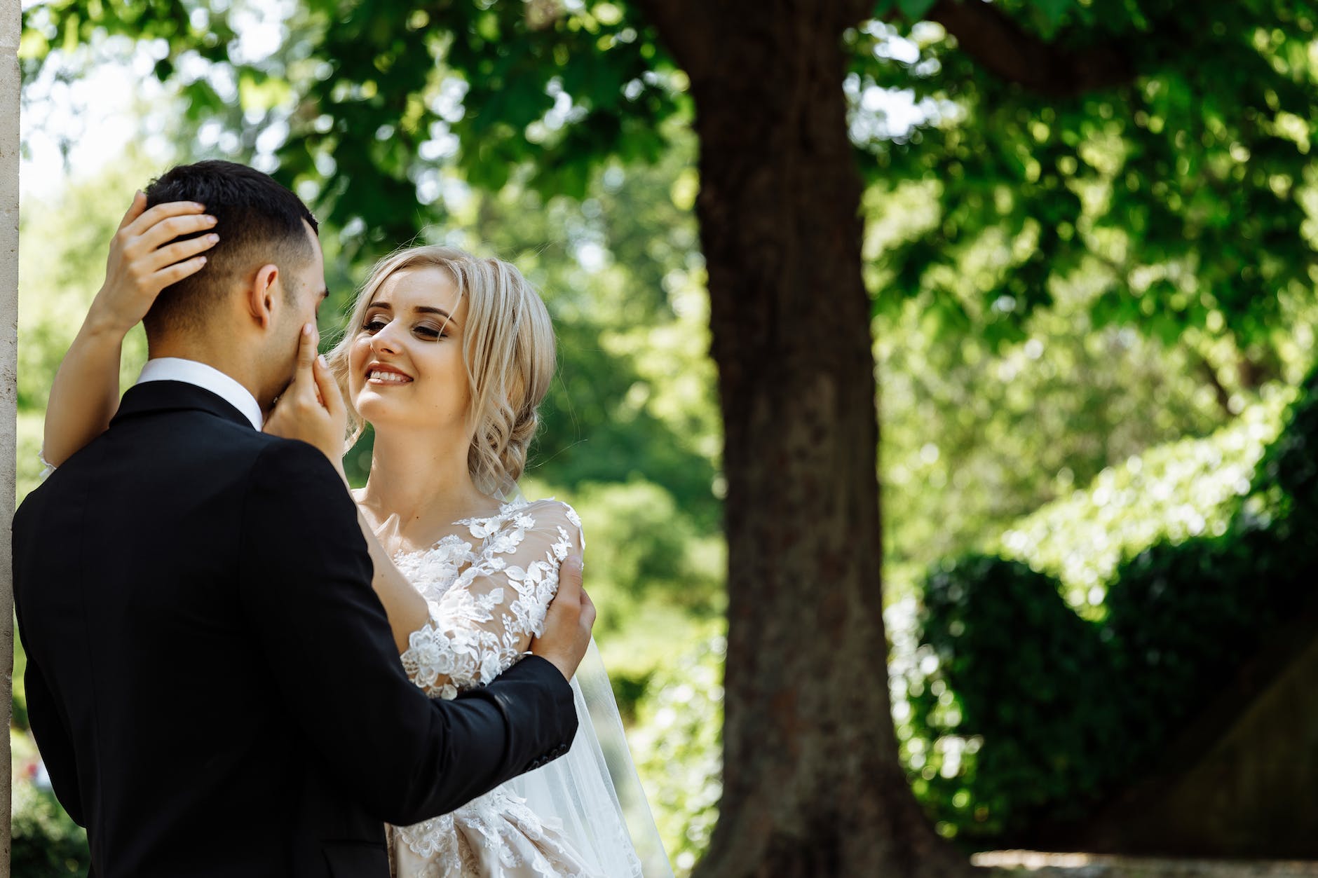couple standing under tree