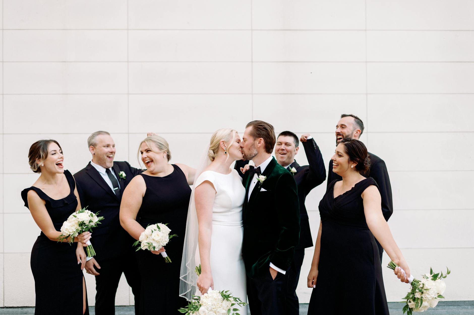newlyweds kissing by guests
