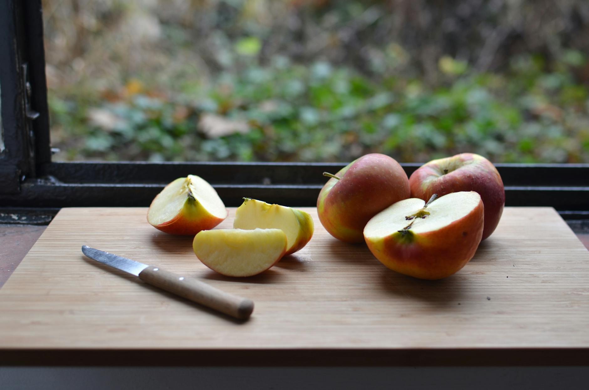 fresh ripe apples placed on wooden chopping board