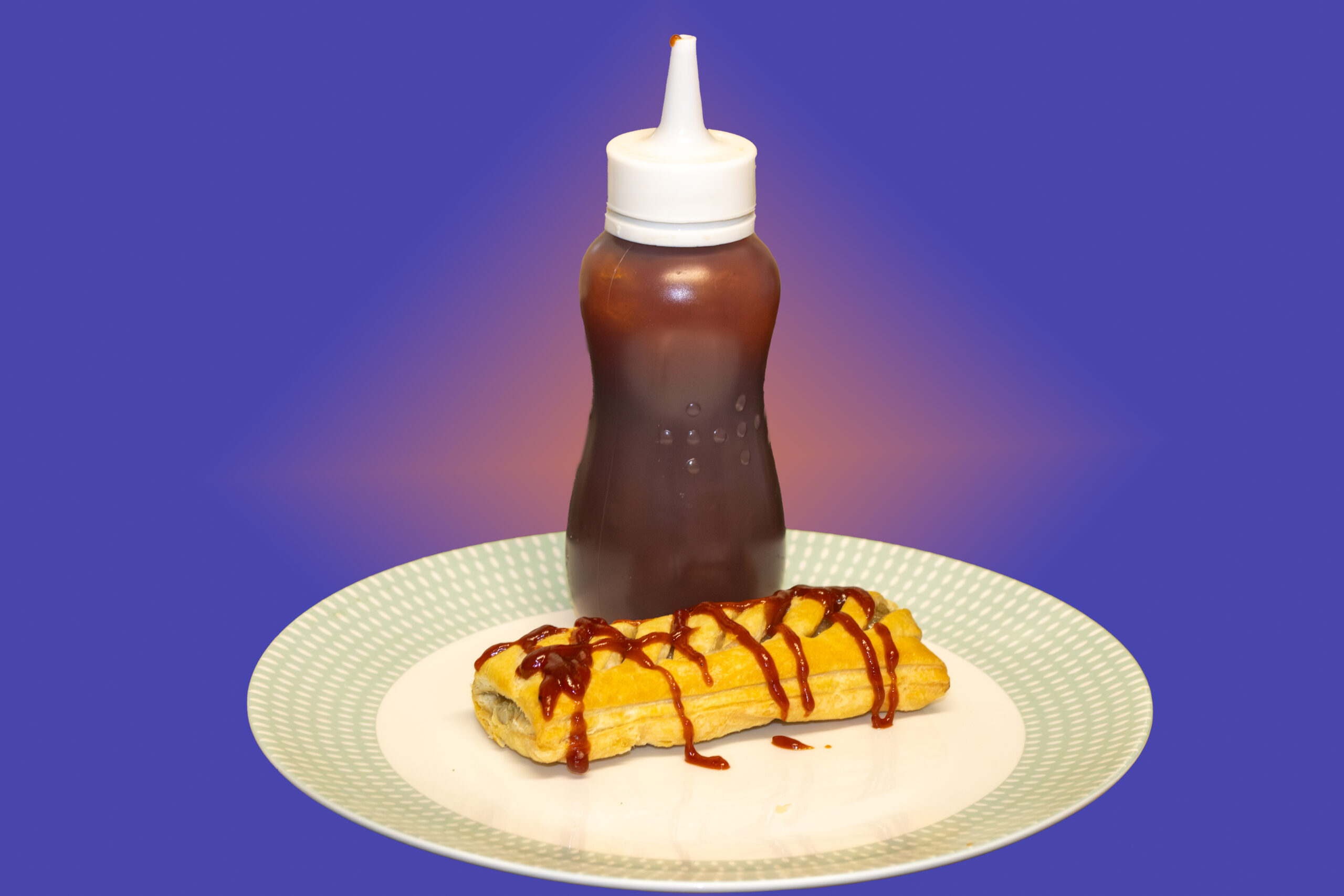 Homemade barbecue sauce in a squeeze bottle beside a plated snack.