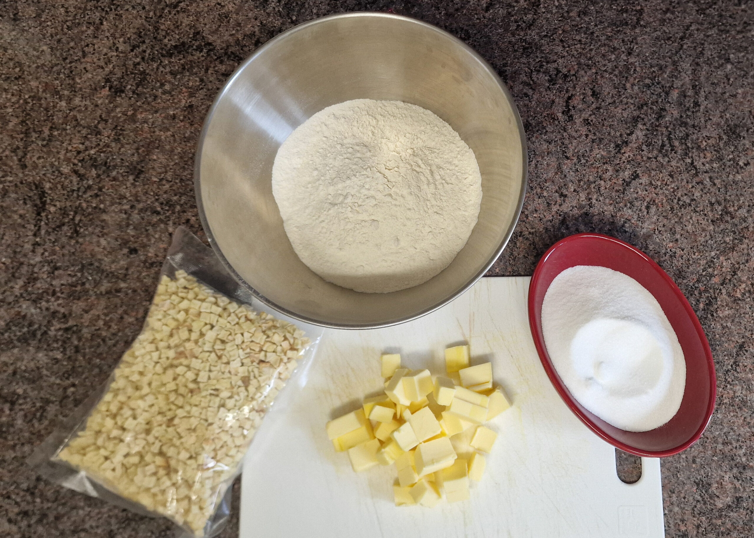 Flour, sugar and other ingredients measured for apple crumble cookies.