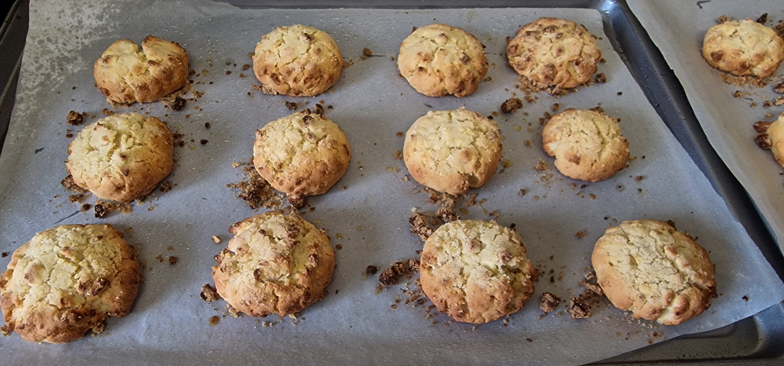 Freshly baked apple crumble cookies cooling on a tray.