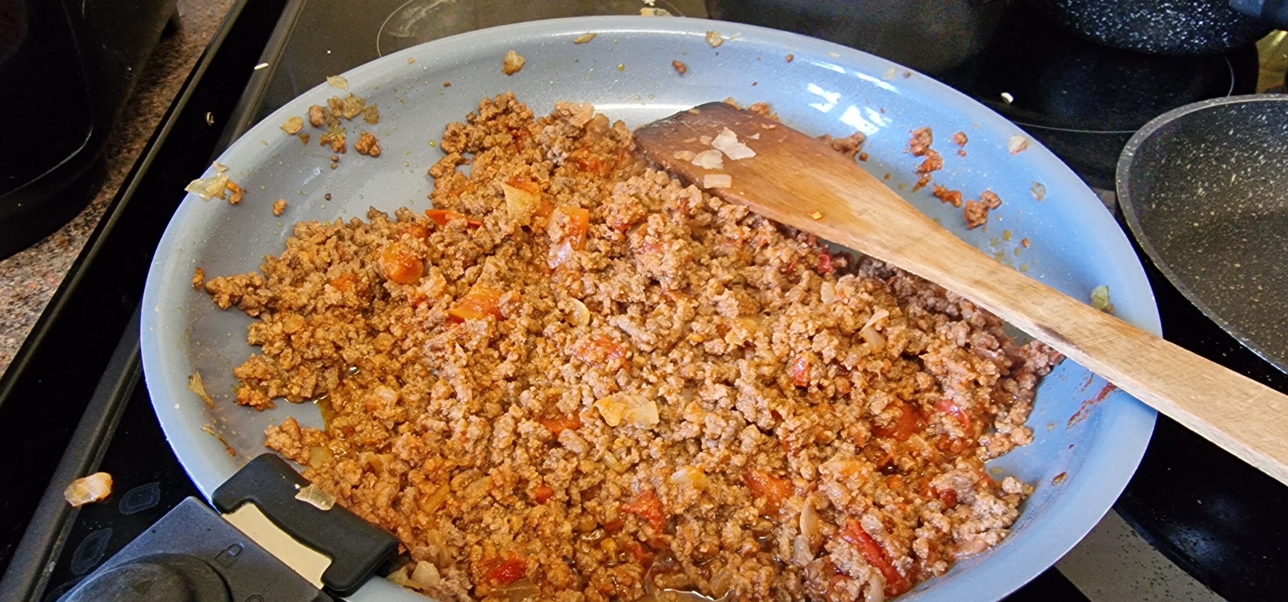 Seasoned mince cooking in a frying pan for arroz a la Cubana.