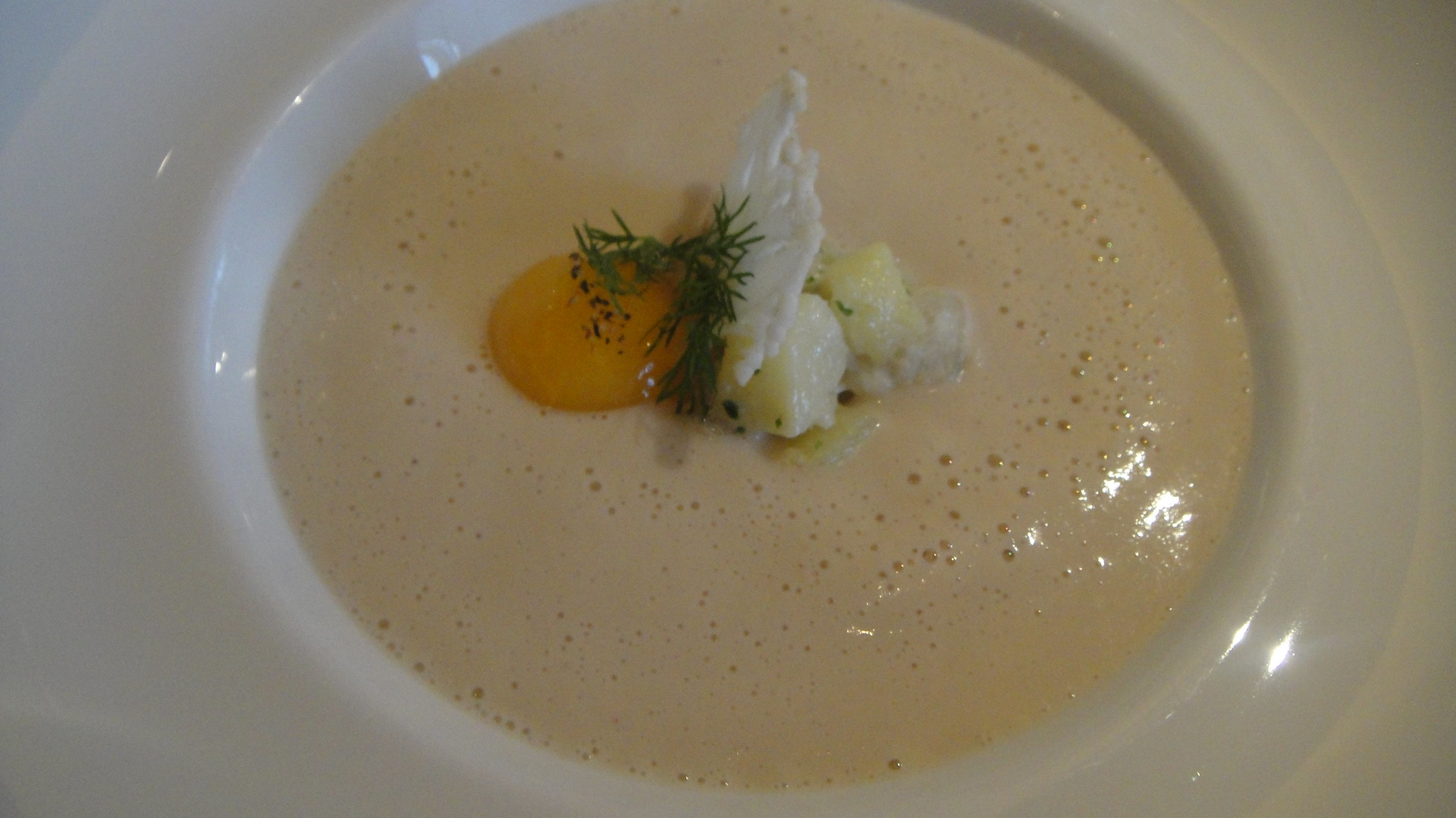 Velouté sauce served in a white bowl with herb garnish.