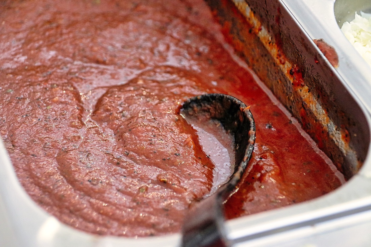 French tomato sauce in a roasting tray with a serving spoon.