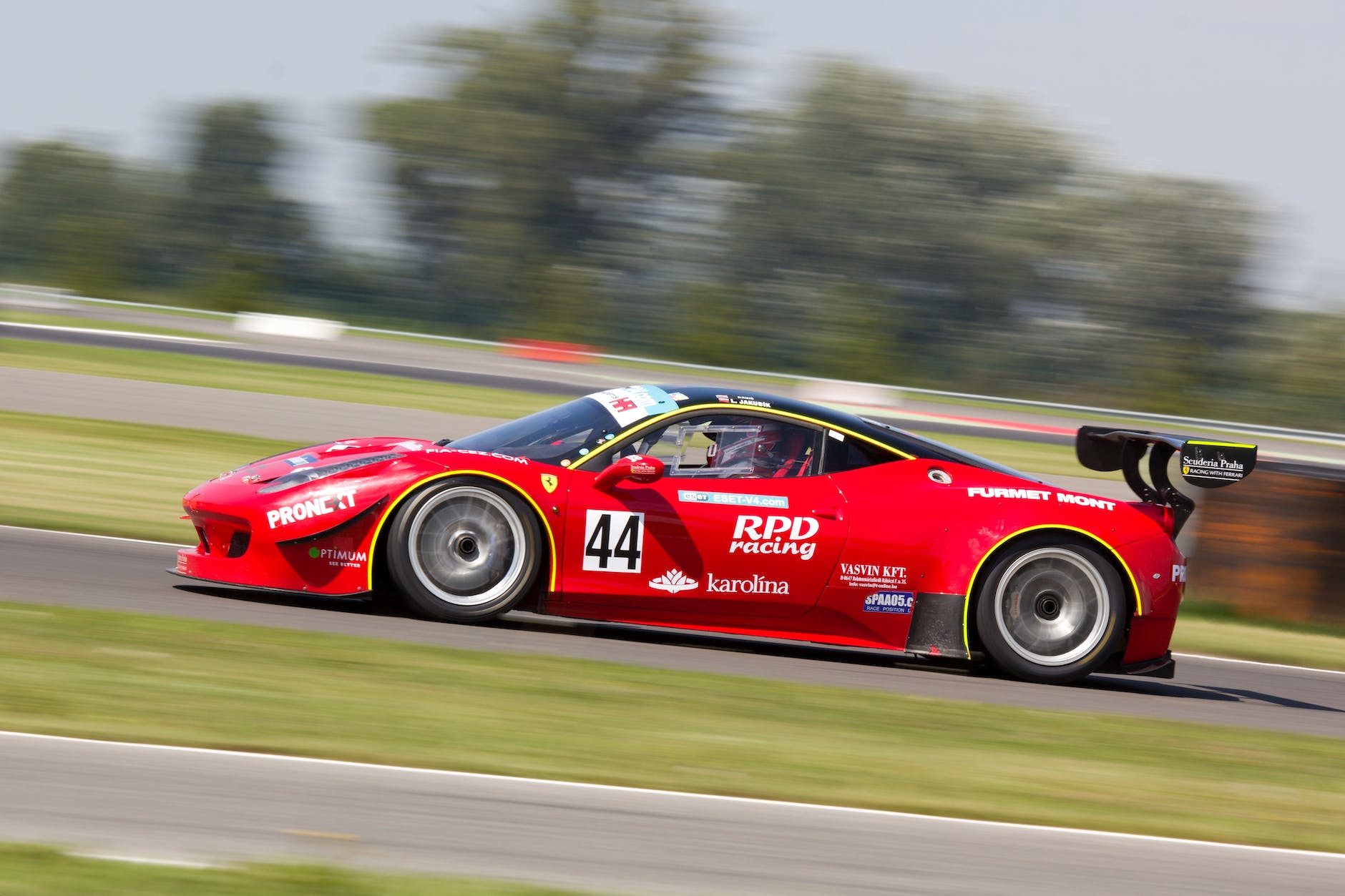 red racing car on race track during daytime