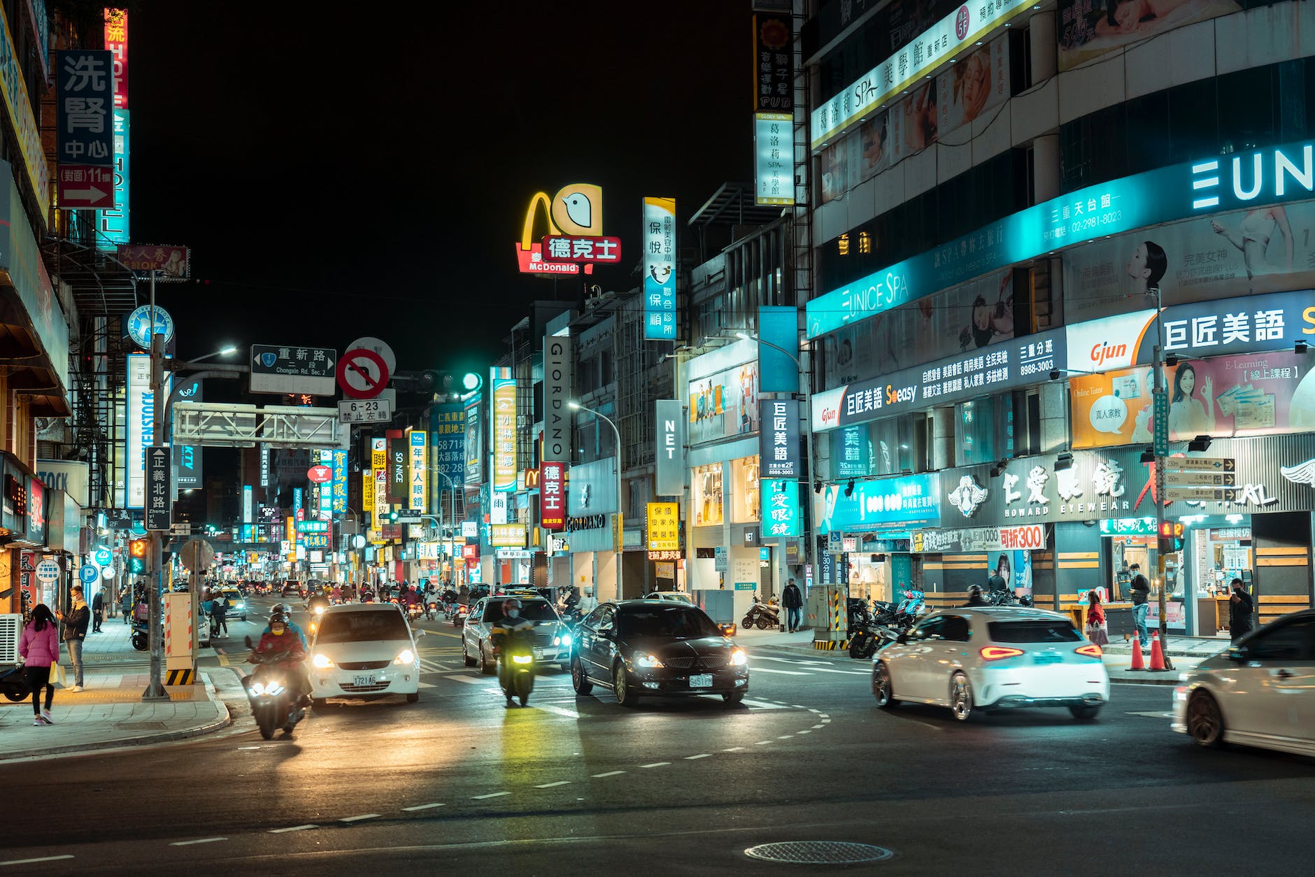moving cars on the road of a city during night time