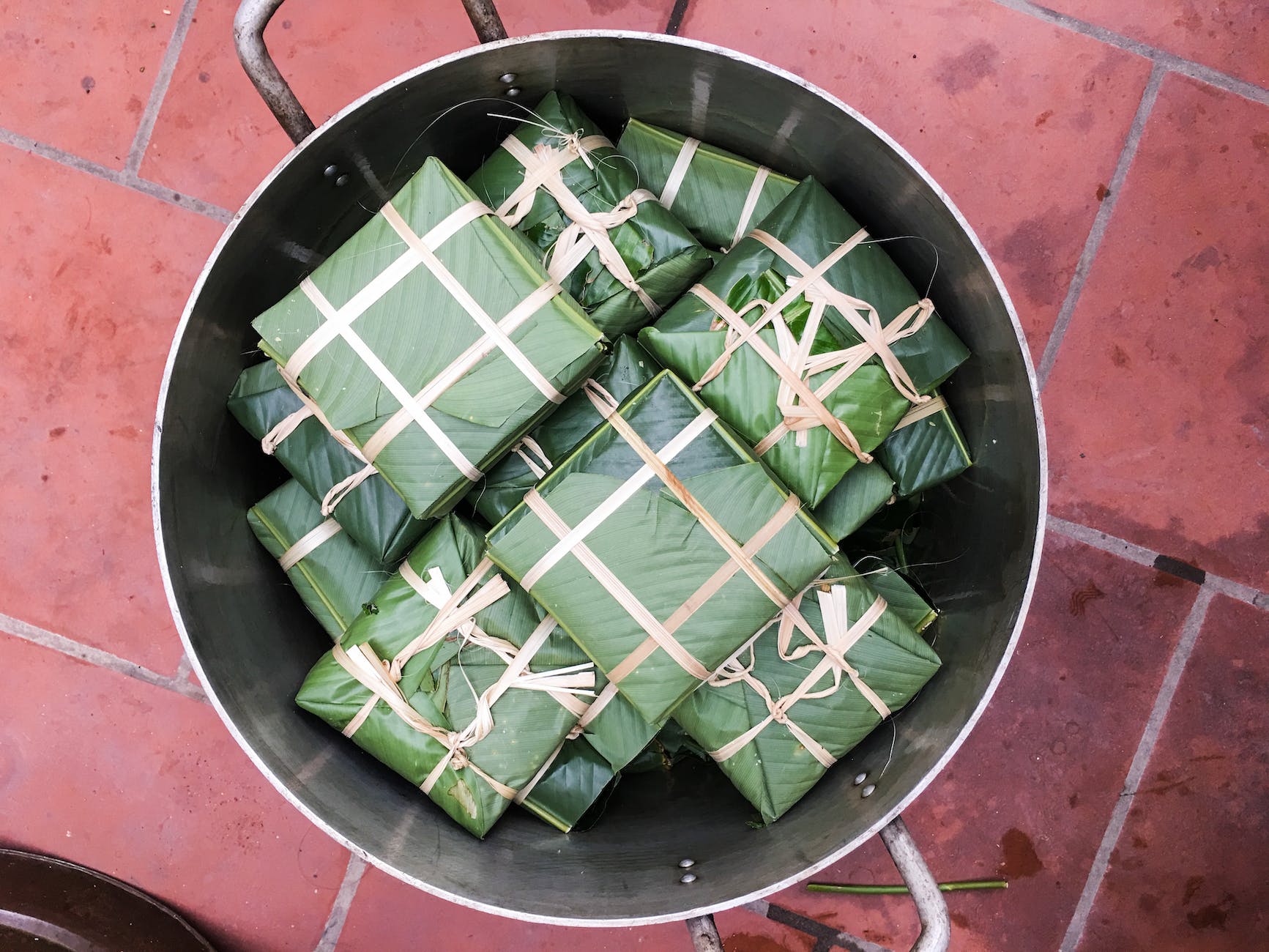 Green-and-white wrapped gifts arranged in a round metal tray.