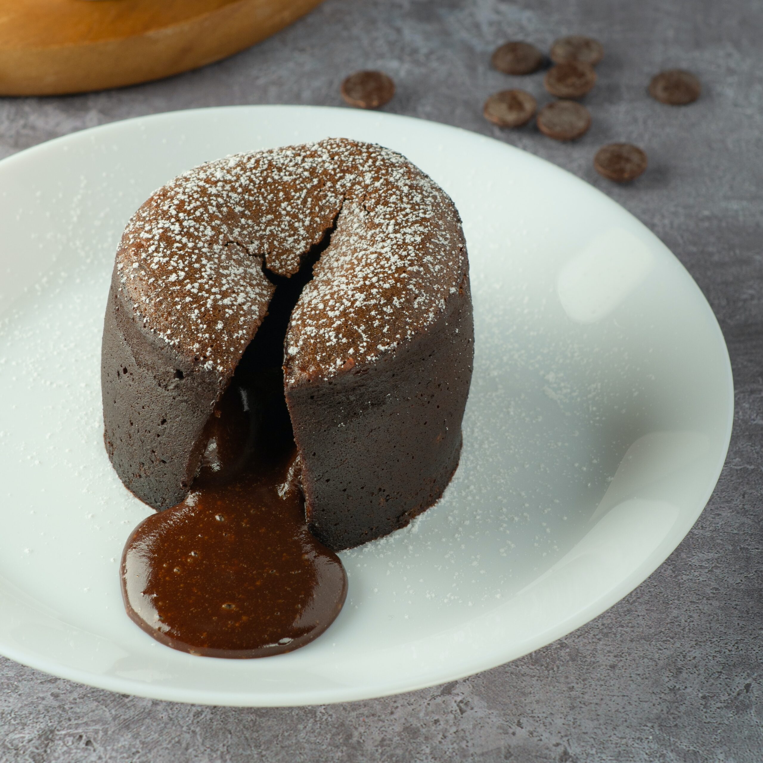 Chocolate fondant with a molten centre on a white plate.